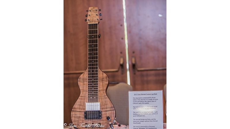 A custom Koa lap steel guitar built by Chris and displayed at the 2018 Hawai&lsquo;i Island Steel Guitar Experience